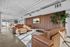 Modern lounge with plush leather sofas, chic decor, and abundant natural light in a stylish apartment setting.