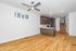 Modern open-concept kitchen with sleek cabinetry and stainless steel appliances, complemented by warm hardwood flooring and bright lighting.