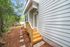 Charming exterior with wooden steps and a serene garden pathway leading to a modern entrance.