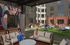 Vibrant outdoor courtyard featuring modern seating, colorful hammocks, and a cozy fire pit, perfect for relaxation and social gatherings.