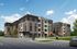 Modern apartment complex with four floors, featuring stylish exterior design and vibrant murals, set against a clear blue sky.