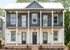 Charming two-story townhouse with elegant gray and white facade, featuring a spacious balcony and multiple entrances.