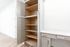 Modern kitchen with ample pantry storage and elegant quartz countertops, featuring sleek cabinet design.