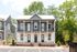 Charming duplex with elegant balconies, surrounded by lush greenery, offering modern living spaces in a serene neighborhood.