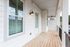 Charming balcony space with elegant wood flooring and modern lighting, perfect for relaxation and outdoor enjoyment.