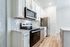Modern kitchen with sleek stainless steel appliances, elegant white cabinetry, and stylish subway tile backsplash.
