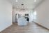 Modern open-concept kitchen with sleek cabinetry, stainless steel appliances, and elegant lighting fixtures, offering a bright and welcoming ambiance.