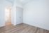 Bright and airy room with elegant white doors and modern wood flooring, ideal for a minimalist design approach.