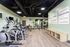 Modern gym with state-of-the-art equipment, motivational wall art, and sleek flooring, perfect for fitness enthusiasts.