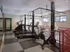 Modern apartment fitness center with sleek treadmills and stationary bikes, offering a bright and inviting workout space.