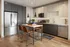 Modern kitchen with sleek stainless-steel appliances, elegant cabinetry, and a chic island with stylish bar stools on hardwood flooring.