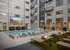 Luxurious apartment courtyard featuring a stylish pool, modern loungers, and a large outdoor screen perfect for entertaining.