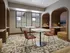 Modern workspace with cozy booths, stylish plaid chairs, and ambient lighting creating a warm and inviting study area.