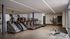 Modern gym with state-of-the-art equipment including treadmills, stair machines, and strength training gear in a sleek, spacious design.