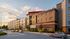 Modern multi-story apartment complex with stylish brick fa&ccedil;ade and large windows, situated on a scenic street with lush landscaping and ample parking.