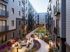 Charming apartment courtyard featuring a vibrant garden, cozy seating areas, and modern building design.