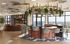 Luxurious open-concept lounge with a stylish circular bar, designer seating, and panoramic floor-to-ceiling windows.