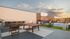Chic rooftop terrace featuring a sparkling pool, cozy lounge chairs, a modern fire pit, and an outdoor entertainment screen.