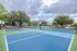 Vibrant tennis courts surrounded by lush greenery, offering a refreshing and active lifestyle in a serene apartment community.
