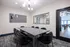 Elegant meeting room featuring a modern table with plush seating, stylish lighting, and a contemporary design.