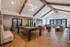 Modern and inviting clubhouse featuring a sleek pool table, cozy seating areas, and vibrant natural light.