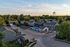 Charming residential community with modern townhouses, refreshing pool area, and lush green surroundings, perfect for peaceful suburban living.