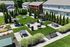 Charming shared backyard with lush green lawns, stylish picnic tables, and modern BBQ grills surrounded by quaint townhouses and vibrant landscaping.