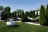 Lush outdoor space featuring elegant hammocks and a sculptural plant surrounded by tall evergreens, perfect for relaxation.