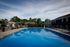 Inviting outdoor pool area with comfortable lounge chairs and scenic greenery, perfect for relaxation and fun.