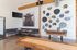 Chic community room featuring rustic wooden accents, a captivating bull painting, and unique circular wall art, perfect for leisure and relaxation.