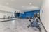 Modern fitness room with sleek exercise bikes, mirrored wall, and vibrant blue accent wall, perfect for energizing workouts.