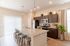 Modern kitchen with sleek granite countertops, stainless steel appliances, and stylish pendant lighting, perfect for culinary adventures.