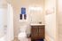 Bright and stylish bathroom with modern fixtures, granite countertop, and cozy decor.