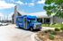 Inviting residential community center with a bright blue shuttle bus, promising convenient living and easy transportation.