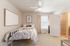Cozy bedroom with stylish decor, featuring a comfortable bed, modern artwork, and spacious walk-in closet.