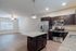 Modern apartment kitchen with elegant granite countertops, stainless steel appliances, and a bright open layout.