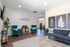 Chic apartment lounge with plush teal chairs, modern decor, and elegant artwork at The Collective at Kennesaw.
