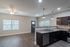 Modern apartment interior with stylish open-concept kitchen, featuring granite countertops, dark wood cabinetry, and elegant fixtures. Spacious living area with abundant natural light and sleek flooring.