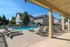 Inviting outdoor pool area with sun loungers and umbrellas, set in a beautifully landscaped courtyard.