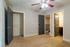 Bright, spacious bedroom with plush carpeting, a modern ceiling fan, and ample closet space, perfect for comfort and convenience.