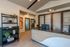 Modern and welcoming office reception area with sleek wooden desk, elegant shelving, and contemporary artwork.