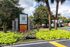 Charming entrance of The Vine at Kenwood, surrounded by lush greenery and vibrant flowers, highlighting a welcoming ambiance.
