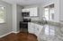 Kitchen with white cabinets and granite countertops