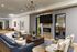 Elegant modern living area featuring chic seating, a sleek fireplace, and a flat-screen TV, perfect for relaxation and entertainment.