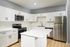 Modern kitchen with sleek stainless steel appliances, elegant white cabinetry, and a chic marble island, perfect for culinary adventures.