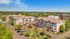 Charming apartment complex with vibrant landscaping, ample parking, and a serene suburban setting, perfect for modern living.