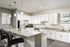 Elegant kitchen with modern white cabinetry, sleek granite countertops, and stylish pendant lighting over a spacious island.