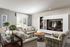 Bright and inviting living room with stylish plaid couches, elegant decor, and a modern entertainment center.