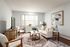Bright and cozy living room with elegant decor, modern furniture, and large windows inviting natural light.