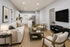 Modern open-plan living room with stylish furniture and a sleek kitchen design, creating a cozy and inviting atmosphere.